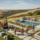Landscape installation crew adding plants and hardscaping beside a backyard pool.